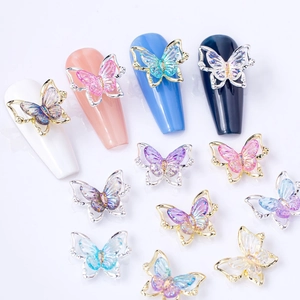 Laser butterfly nail charms with iridescent finish and gold metal frame on nails