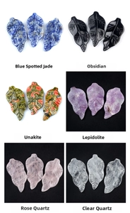 Macro view of carved leaf pendants in natural stones like obsidian and rose quartz