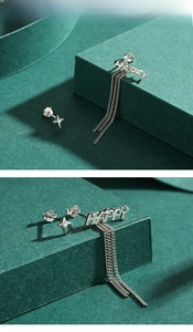 Detailed view of S925 silver asymmetric earrings with HAPPY letters and tassel chain