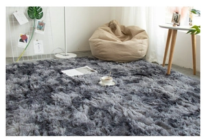 Detail of plush grey gradient rug texture in a cozy living room setting