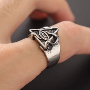 Macro shot of retro silver ring featuring all-seeing eye and coiled snake details