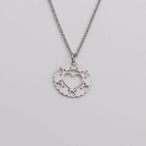 Elegant stainless steel necklace with a round hollow heart pattern pendant on white base