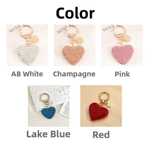 Detail of heart-shaped rhinestone keychains in five vibrant colors with gold rings