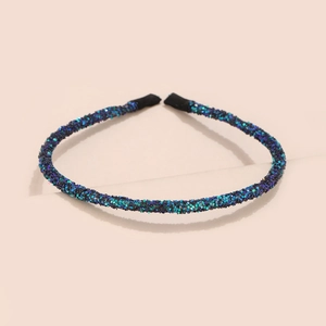 Detail view of teal gradient sequins headband with glitter finish and black inner lining