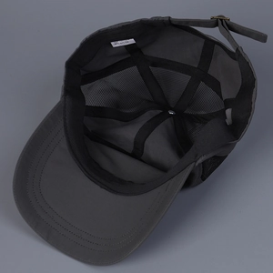 Interior detail of breathable dark gray mesh baseball cap with cotton nylon blend fabric