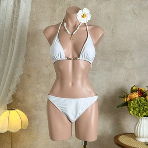 Detail of white bikini top with exquisite pearl and metal ring buckle hardware