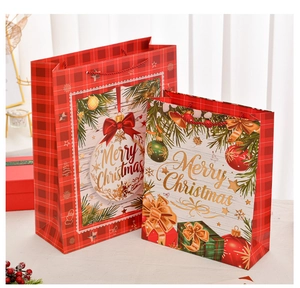 Detail view of festive red plaid Christmas gift boxes in two sizes with Merry Christmas text