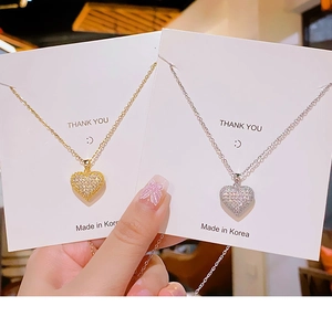 Detail of heart necklaces in gold and silver finish with sparkling pave set zircons