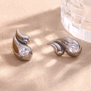 Macro shot of silver teardrop earrings with sparkling pear-cut cubic zirconia crystals