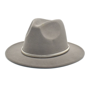 Detail of grey wool fedora hat with a thin gold metal band and wide flat brim