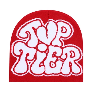 Detailed view of red knitted beanie featuring bold white TVP TIER jacquard lettering