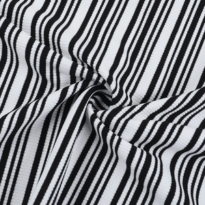 Detailed view of black and white striped knit fabric with fine ribbed texture for dresses