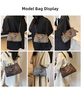 Detail view of leopard print crossbody bag with metallic T-shaped lock and chain strap