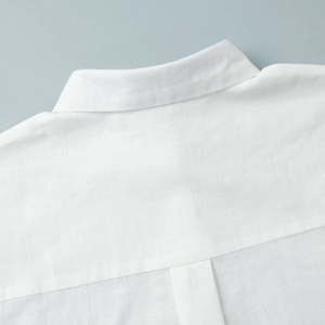 Close-up of white linen shirt collar and yoke detailing with high-quality stitching texture