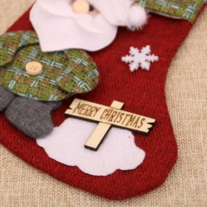 Detail of red burlap Christmas stocking with 3D Santa Claus and Merry Christmas tag