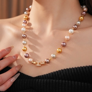 Detail of multi-color pearl necklace with crystal-set golden rectangle clasp closure