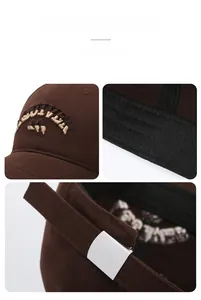 Detail of dark brown cotton baseball cap showing 3D embroidery and metal buckle