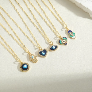 Golden Evil Eye necklaces featuring Hamsa, heart and round pendants with sparkling zircons