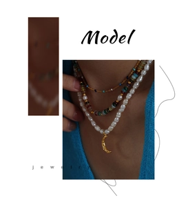 Close-up of bohemian layered pearl and colorful bead necklaces with gold moon pendant on model