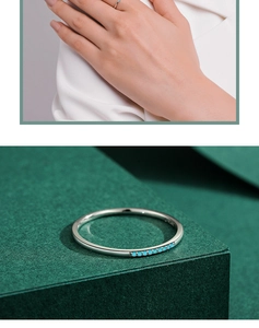 Detailed view of a slim S925 sterling silver ring featuring a round turquoise gemstone