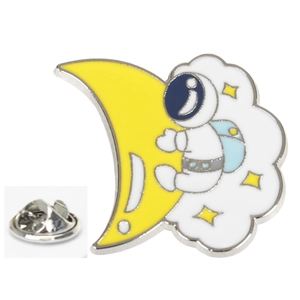 Detail of cartoon astronaut brooch featuring a yellow moon, white clouds, and gold stars