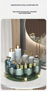 Detail of green rotating vanity organizer tray with gold legs on marble countertop
