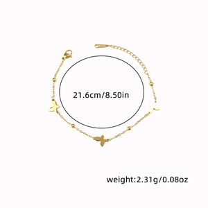 Macro detail of a gold butterfly bracelet with S-STEEL tag and measurement markers