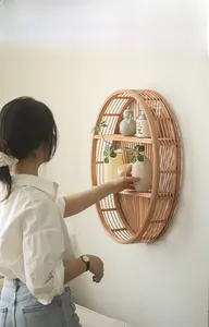 Detail of handcrafted oval bamboo wall shelf with natural textures for home decoration