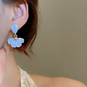 French style light blue petal drop earrings with gold core worn by a model