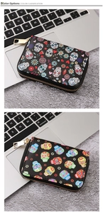 Macro detail of gothic skull printed PU leather wallets with golden metal zippers