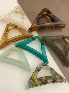 Macro shot of geometric triangular hair claws in amber and tortoise shell finishes