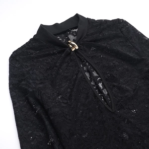 Detail of black lace dress featuring a cutout neckline with golden decorative metal buckle