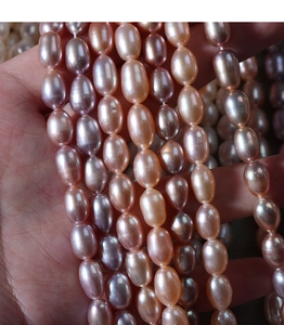 Detail showing 5-6mm natural freshwater rice pearls in pink gradient for jewelry making