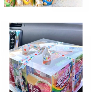 Detail of DIY birthday gift box with colorful snacks and Happy Birthday decorative ribbon
