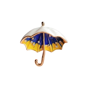 Golden umbrella brooch with white enamel, starry crystals and blue gradient details