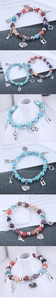 Macro detail of bohemian beaded bracelet with turquoise stones and heart lock pendants