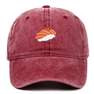 Detail of red washed cotton baseball cap with sushi embroidery and vintage texture