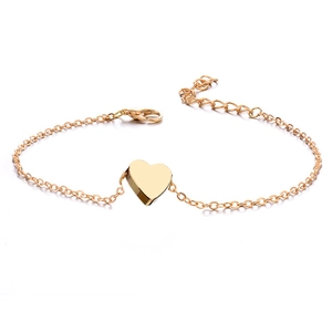 Gold beaded chain anklet with heart pendant and lobster clasp on white background