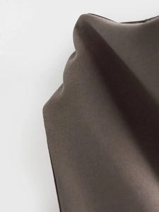 Macro shot of dark brown fabric texture and detailed weaving for minimalist women's set