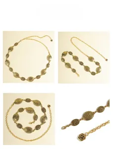 Detail of vintage gold metal chain belt with oval floral patterns and rose pendant