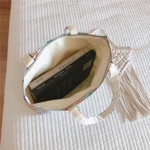 Top view of floral cotton handbag showing large capacity with books and zipper detail