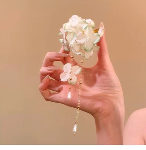 Detail view of floral hair clip with pearl tassels and gradient fabric petals