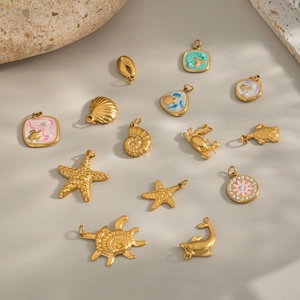 Detailed close-up of golden sea-themed animal pendants with colorful enamel and pearls