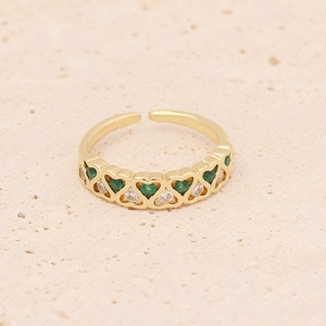 Green and white zircon heart-shaped gold open ring on textured stone background