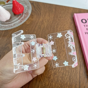 Acrylic Christmas hair claw clip with snowflake patterns and festive lettering