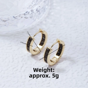 Macro detail of gold hoop earrings with black rectangular inlay and exact dimensions