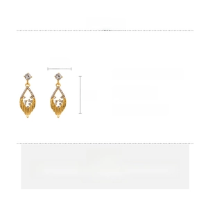 Detail view of gold hollow leaf earrings with diamonds and dimensions measurements