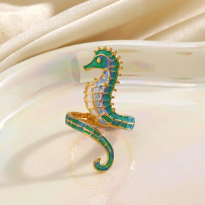 Elegant gold seahorse open ring with blue and green enamel on a silk background