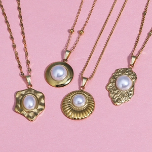 Minimalist 18K gold-plated stainless steel shell and pearl flower pendants on pink backdrop