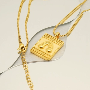 Gold plated stainless steel necklace featuring a square rainbow and moon relief pendant